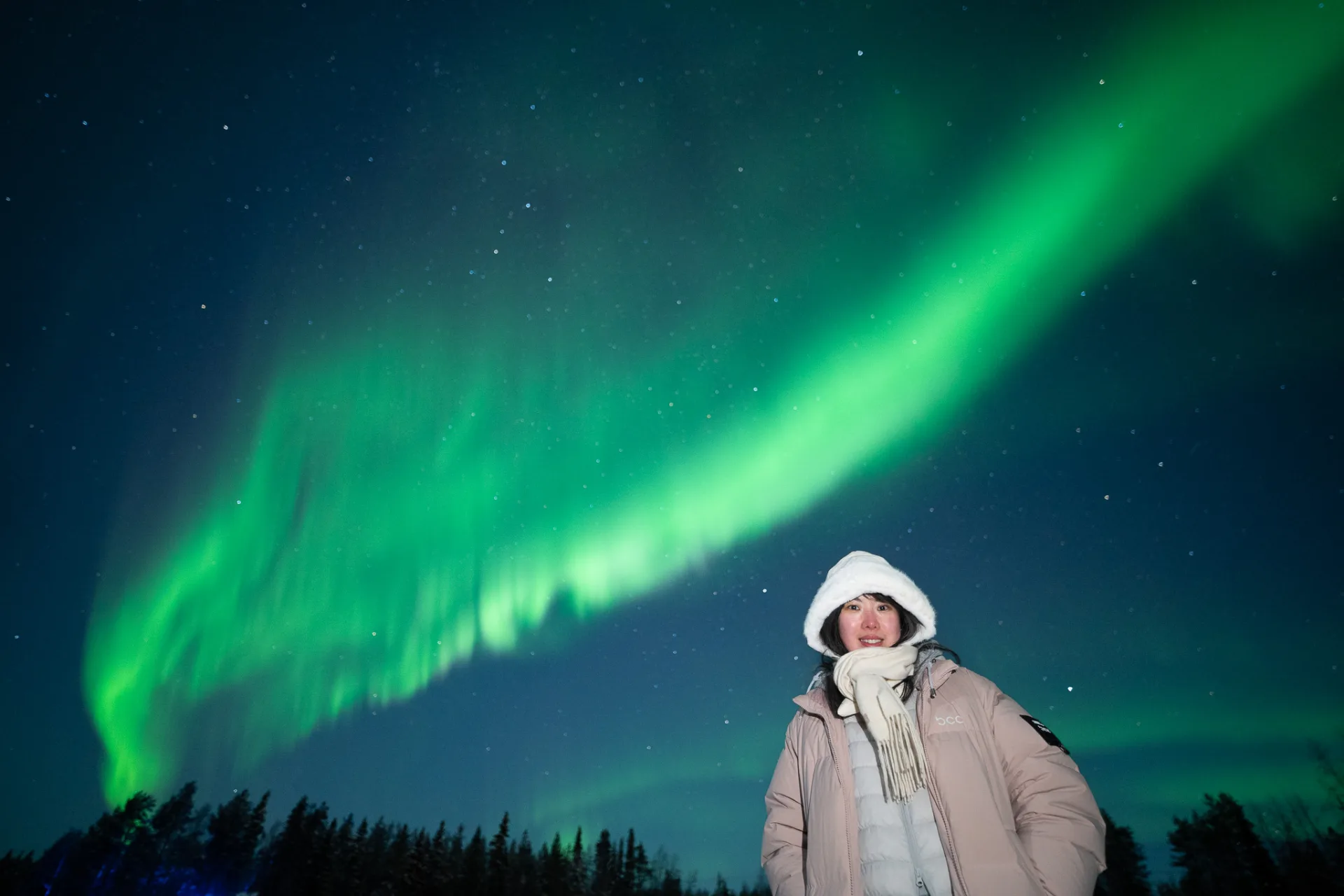 Wide aurora sweeping over a dusk horizon in Lapland near Rovaniemi